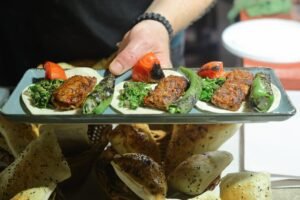 plate-with-shish-adana-kebab-hands-cook-closeup_205832-3544